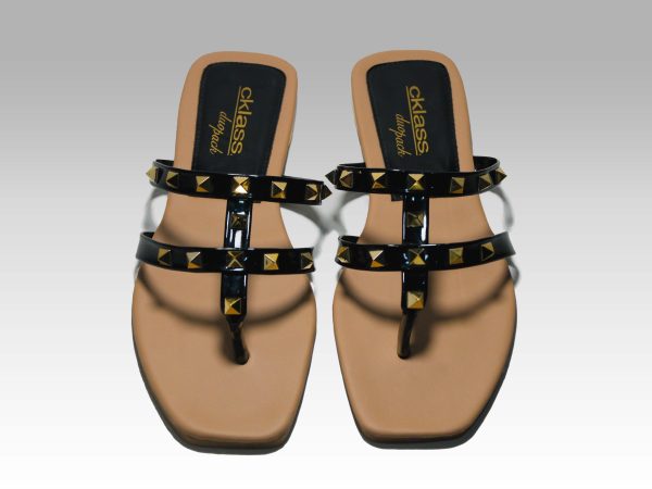 Sandalias de metededo de tiritas negras con pirámides doradas, vista frontal.