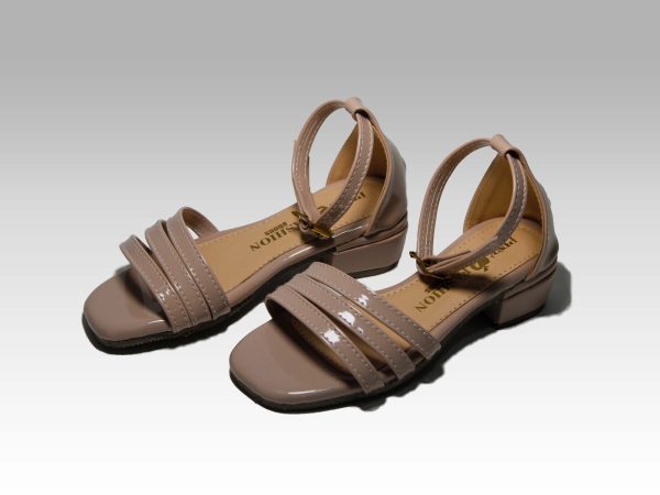 Sandalias beige de niñas con tacón, con tiritas en el empeine y talón con herraje, vista lateral.