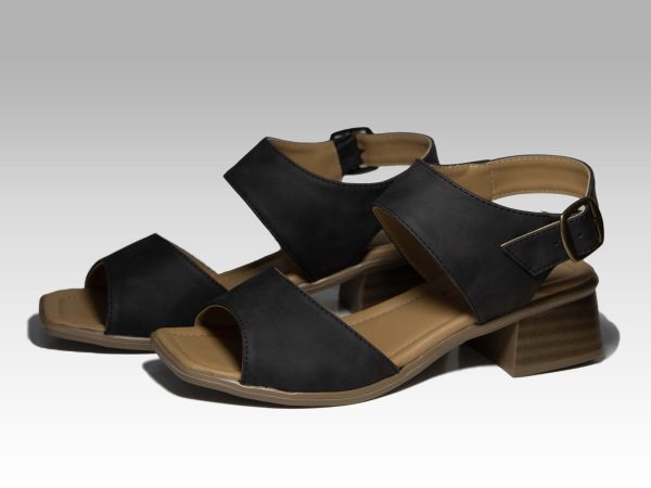 Sandalias negras de tacón con banda en el empeine y con talón, vista lateral.